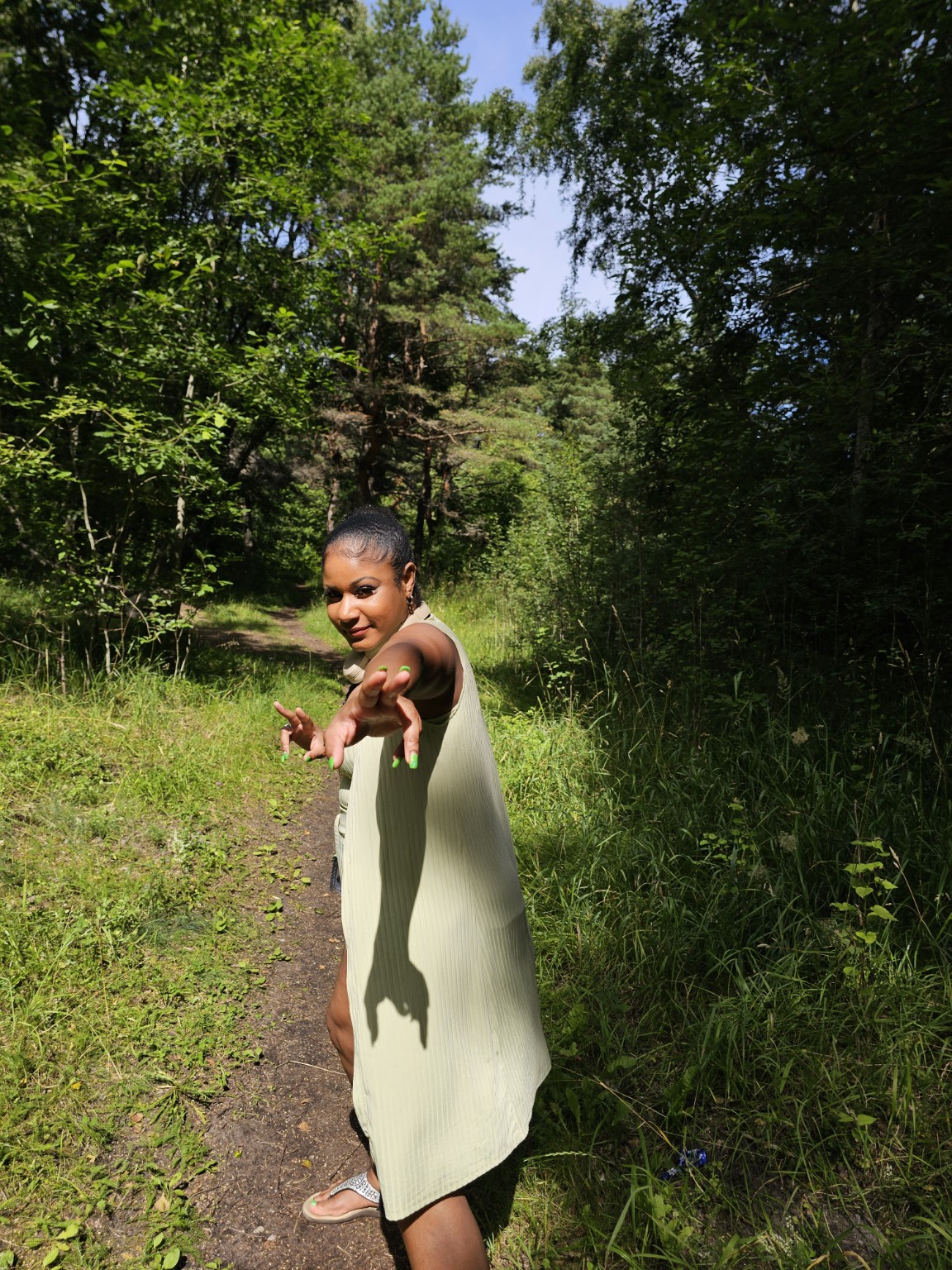 Jade reaching out warmly on a sunlit woodland path